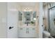Stylish bathroom featuring a vanity with white cabinets, black hardware, and a walk-in shower at 21940 N 69Th Dr, Glendale, AZ 85310
