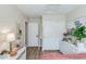 Bright bedroom with a white dresser, macrame wall art, and wood-look flooring at 21940 N 69Th Dr, Glendale, AZ 85310