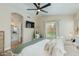 Comfortable bedroom with an ensuite bathroom, accent mirror, and soft, neutral décor at 21940 N 69Th Dr, Glendale, AZ 85310