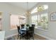 Dining area with modern light fixture, hardwood flooring, and window views at 21940 N 69Th Dr, Glendale, AZ 85310