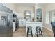 Bright kitchen with white cabinets, stainless steel appliances, and a center island with breakfast bar at 21940 N 69Th Dr, Glendale, AZ 85310