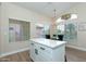 Bright kitchen area with a white island, quartz countertops, and dining table at 21940 N 69Th Dr, Glendale, AZ 85310