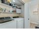 Functional laundry room with modern washer, dryer, and shelving for storage at 21940 N 69Th Dr, Glendale, AZ 85310
