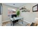 Cozy home office with modern desk, black chair, and bright natural light at 21940 N 69Th Dr, Glendale, AZ 85310