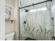 Modern bathroom shower featuring sleek tile design, black fixtures, and glass enclosure at 21940 N 69Th Dr, Glendale, AZ 85310
