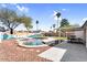 Outdoor living area with a pool, lounge chairs, a mural, and a dining area, perfect for entertaining at 2232 E Karen Dr, Phoenix, AZ 85022