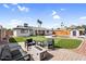 Inviting backyard featuring a putting green, pool, outdoor seating, and a modern fire pit, perfect for entertaining at 2232 E Karen Dr, Phoenix, AZ 85022