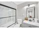 Modern bathroom with a tub-shower, sleek black hardware, and stylish vanity providing a clean and functional space at 2232 E Karen Dr, Phoenix, AZ 85022