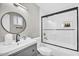 Updated bathroom featuring white subway tile shower with black trim, modern vanity, and built-in shelving at 2232 E Karen Dr, Phoenix, AZ 85022