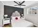 Serene bedroom with dark accent wall, tufted headboard, and matching white nightstands adding style and comfort at 2232 E Karen Dr, Phoenix, AZ 85022