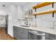 Modern kitchen with stainless steel appliances, gray cabinets, and subway tile backsplash at 2232 E Karen Dr, Phoenix, AZ 85022