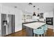 Large kitchen with white cabinets, stainless steel appliances, and an eat-in island at 2232 E Karen Dr, Phoenix, AZ 85022