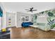 Open-concept living room with hardwood floors, stylish sofas, and a modern ceiling fan at 2232 E Karen Dr, Phoenix, AZ 85022