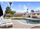 Serene pool area with a putting green, lounge chairs, and a well-maintained yard, ideal for leisure at 2232 E Karen Dr, Phoenix, AZ 85022