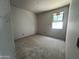 An unfinished bedroom space with a window letting in natural light, ready for personalization at 22812 E Lords Way, Queen Creek, AZ 85142