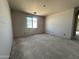 Bedroom featuring unfinished walls, a large window providing natural light, and spacious layout at 22812 E Lords Way, Queen Creek, AZ 85142