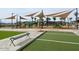 Inviting community space featuring a playground, seating, shade sails and bocce court at 22812 E Lords Way, Queen Creek, AZ 85142