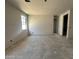 Spacious living room featuring unfinished walls, a window providing natural light, and ample space at 22812 E Lords Way, Queen Creek, AZ 85142