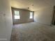 Spacious living room featuring unfinished walls, windows providing natural light, and ample space at 22812 E Lords Way, Queen Creek, AZ 85142