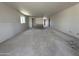 Large living room with unfinished walls, a view through to other rooms, and ample space at 22812 E Lords Way, Queen Creek, AZ 85142