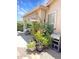 Covered back porch with outdoor furniture, flowers, plants, awning, and gas grill at 2394 E Santiago Trl, Casa Grande, AZ 85194