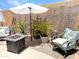 Landscaped backyard with an outdoor seating area, fire pit, and lush greenery for serene relaxation at 2394 E Santiago Trl, Casa Grande, AZ 85194