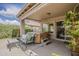 Covered patio featuring a hot tub, comfortable seating, and lush greenery at 2394 E Santiago Trl, Casa Grande, AZ 85194