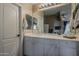 Bright bathroom with white vanity, large mirror, and ample lighting fixtures at 2394 E Santiago Trl, Casa Grande, AZ 85194
