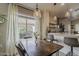 Cozy dining area features a wood table, pendant lighting, and natural light from the large window at 2394 E Santiago Trl, Casa Grande, AZ 85194