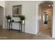 Bright entryway features neutral walls, tile flooring, decorative table with plants, and an arched doorway at 2394 E Santiago Trl, Casa Grande, AZ 85194