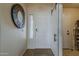 Inviting entryway with a decorative mirror, neutral tones and sidelight window for natural light at 2394 E Santiago Trl, Casa Grande, AZ 85194
