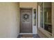 Inviting front door with decorative wreath and sidelight window at 2394 E Santiago Trl, Casa Grande, AZ 85194