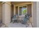 Covered front porch features cozy chairs perfect for enjoying the outdoors at 2394 E Santiago Trl, Casa Grande, AZ 85194