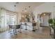 Bright kitchen and dining area with modern pendant lighting, counter seating and open layout at 2394 E Santiago Trl, Casa Grande, AZ 85194