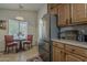 Cozy kitchen nook with table, chairs, natural light, and stainless steel refrigerator at 2394 E Santiago Trl, Casa Grande, AZ 85194
