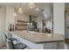 Kitchen featuring an island, barstool seating, pendant lights, and stainless steel appliances at 2394 E Santiago Trl, Casa Grande, AZ 85194