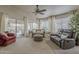 Comfortable living room with large windows, an area rug, and sliding glass doors to the backyard at 2394 E Santiago Trl, Casa Grande, AZ 85194