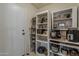 Walk-in pantry with shelving and door for organized storage of food and kitchen essentials at 2394 E Santiago Trl, Casa Grande, AZ 85194