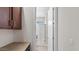 A bathroom with a shower stall, a white door and wood cabinets at 2530 N Pony Ln, Casa Grande, AZ 85122