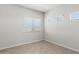 Empty bedroom with neutral tile flooring, three windows, and fresh paint at 2530 N Pony Ln, Casa Grande, AZ 85122