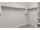 Walk-in closet with built-in shelves and carpet flooring at 2530 N Pony Ln, Casa Grande, AZ 85122