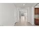 Bright and airy hallway with neutral paint, tile flooring, and a clear view to the back of the house at 2530 N Pony Ln, Casa Grande, AZ 85122