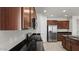 Open kitchen with granite countertops, stainless appliances and dark wood cabinetry at 2530 N Pony Ln, Casa Grande, AZ 85122