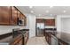 Modern kitchen features granite counters, stainless steel appliances, and wooden cabinetry at 2530 N Pony Ln, Casa Grande, AZ 85122