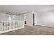 Spacious carpeted loft with white railing overlooking below and natural light at 2530 N Pony Ln, Casa Grande, AZ 85122