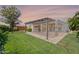 Outdoor living with a covered patio and lush green lawn for entertaining and relaxing under the Arizona sky at 26733 W Melinda Ln, Buckeye, AZ 85396
