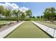Outdoor bocce ball courts lined with trees and charming seating areas, ideal for friendly games at 26733 W Melinda Ln, Buckeye, AZ 85396