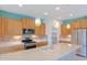 Well-lit kitchen features quartz countertops, stainless appliances, and decorative pendant lights at 26733 W Melinda Ln, Buckeye, AZ 85396