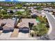 Aerial view showing the home's desert landscaping, a well-maintained lawn, and mature trees at 29023 N 48Th Ct, Cave Creek, AZ 85331
