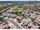 This wide aerial shot features a community with pools, desert landscaping, and mountain views on the horizon at 29023 N 48Th Ct, Cave Creek, AZ 85331